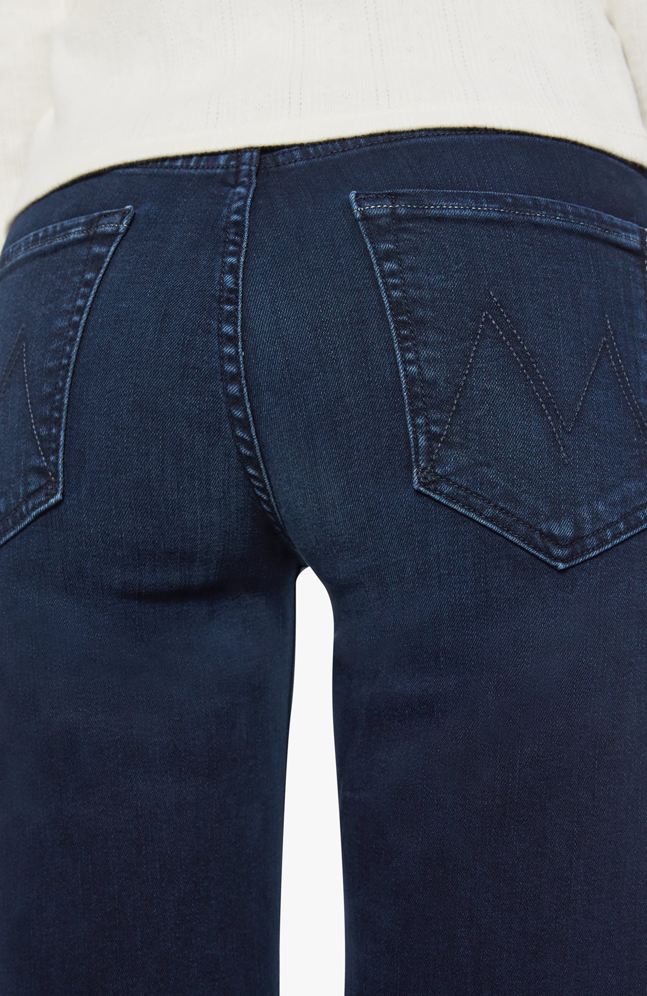 Close-up of dark blue jeans on a white background