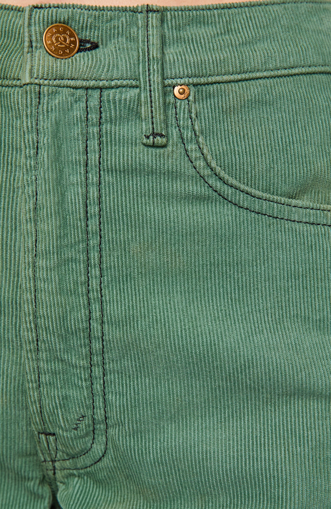 Close-up of a pair of green corduroy pants showing the waistband, belt loop, button, front pocket, and rivet.