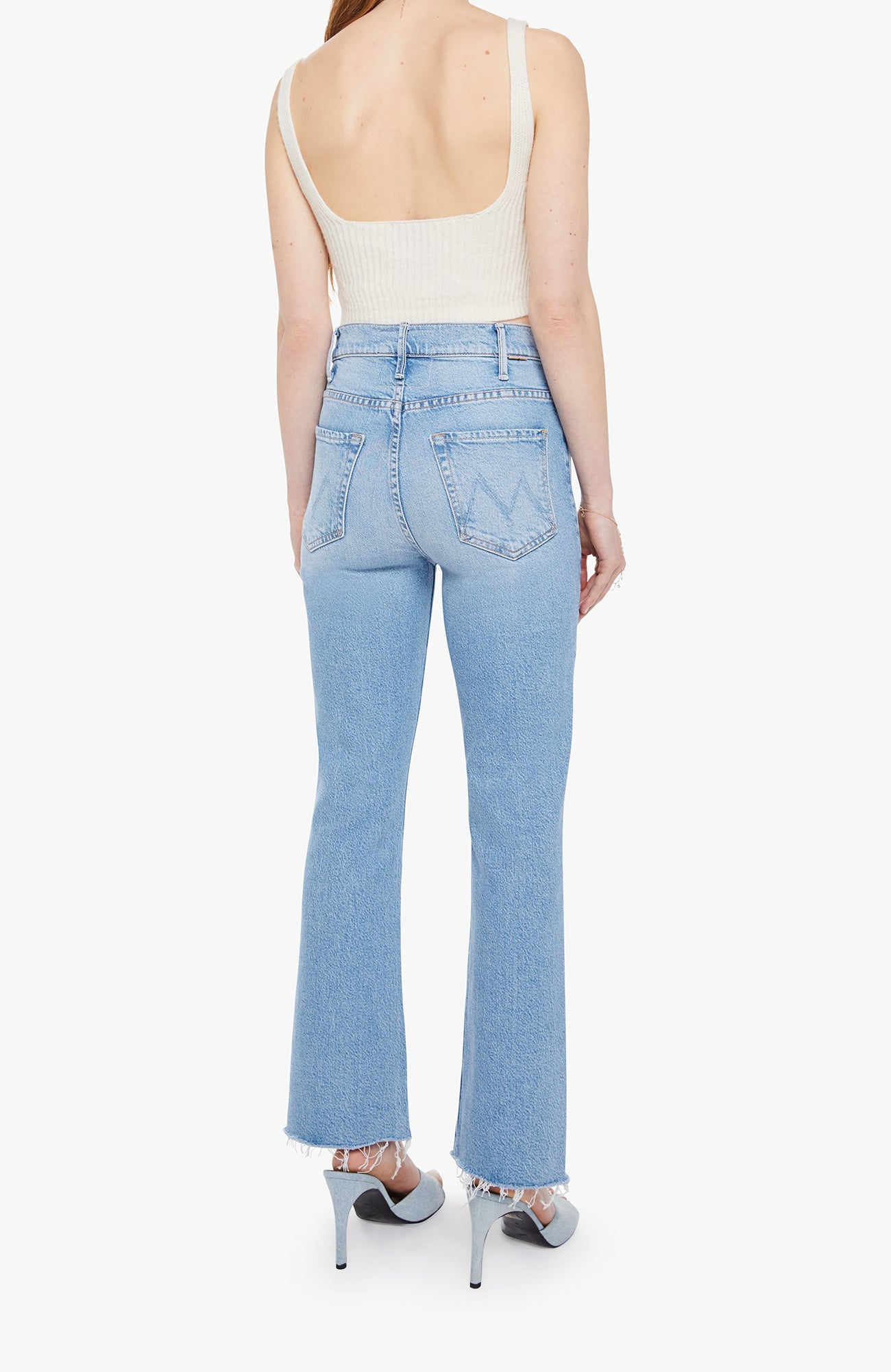 Light blue jeans worn by a person on a white background