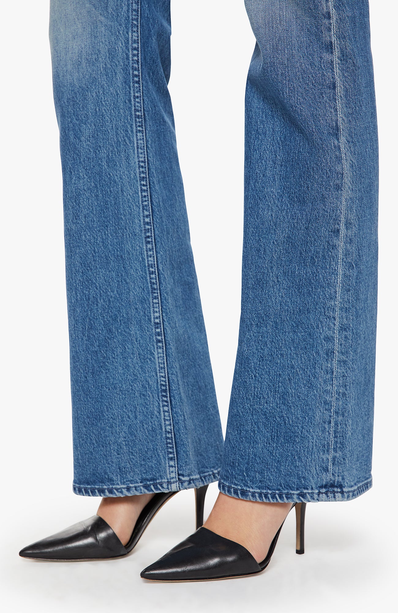 Blue jeans and black high-heeled shoes on a white background