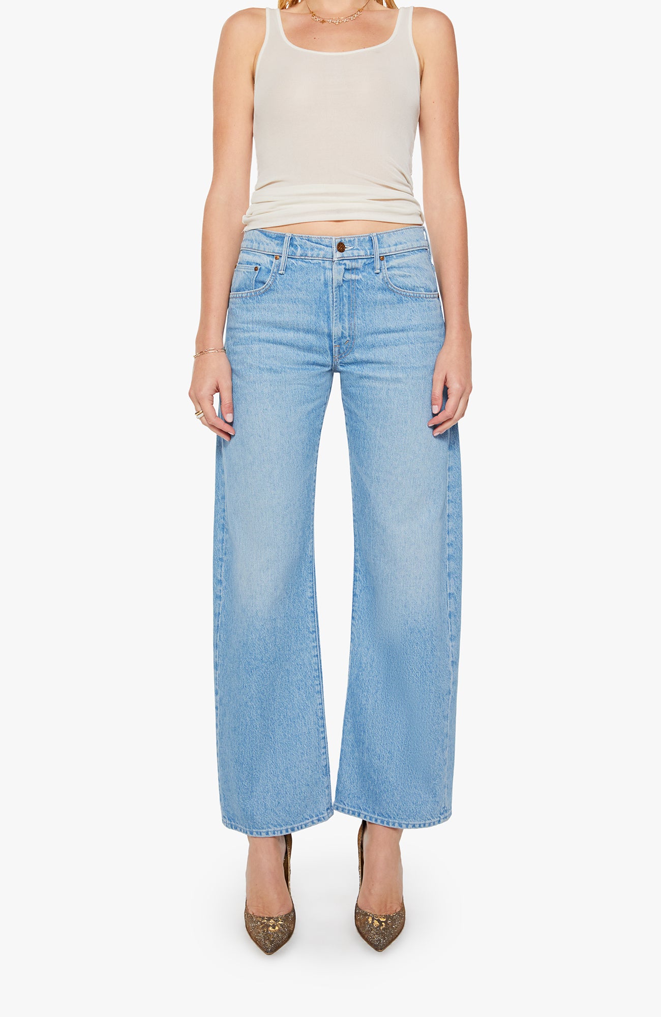 Person wearing light blue jeans and a white tank top on a white background