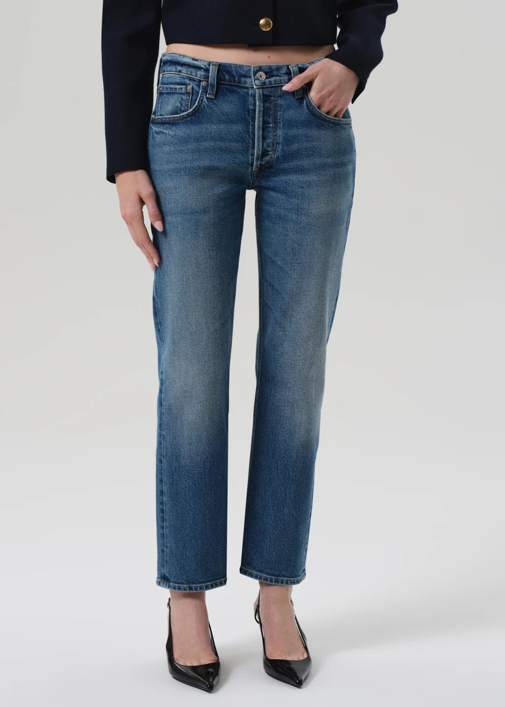 Person wearing blue jeans on a white background