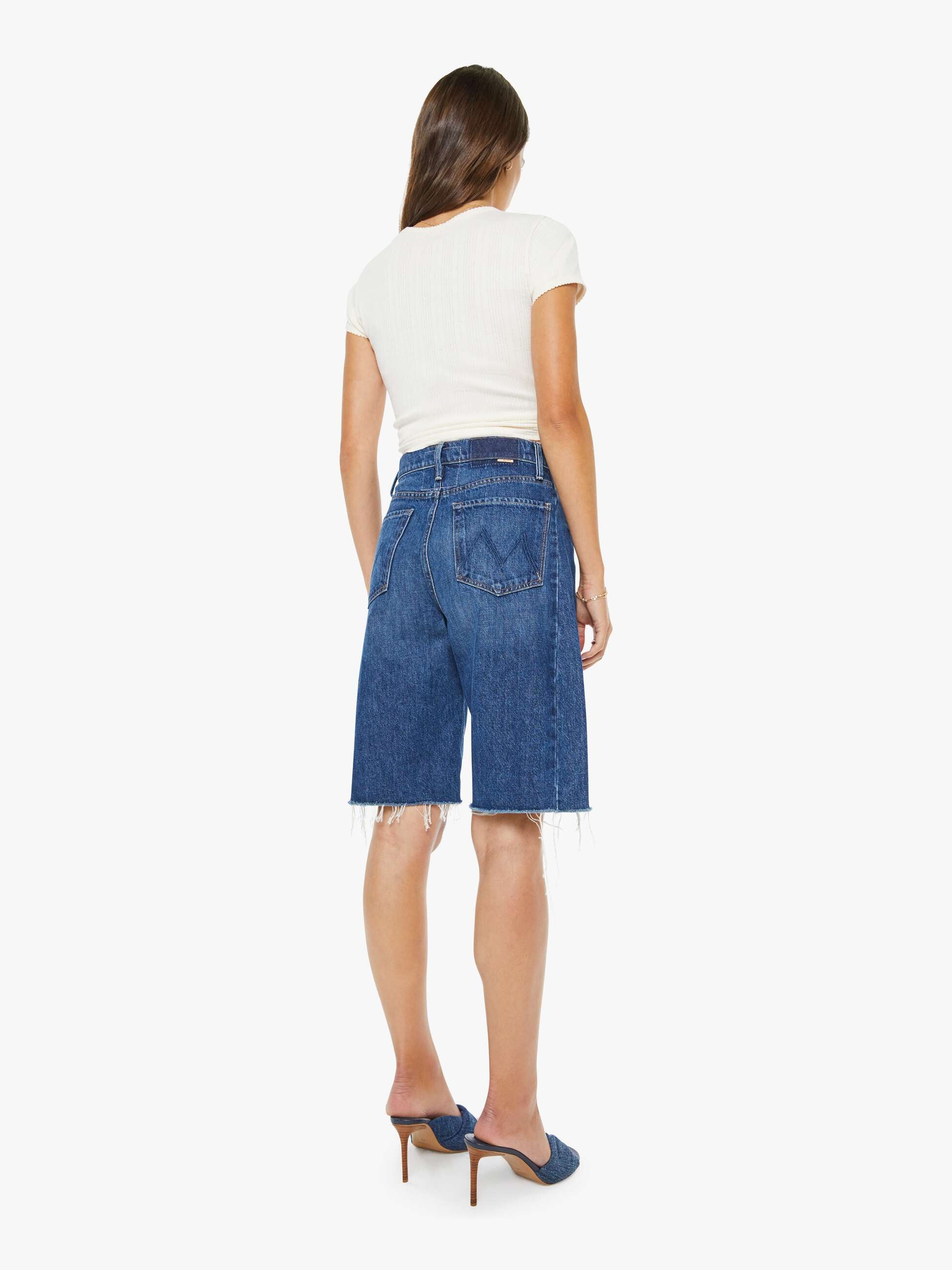 Woman wearing blue denim shorts on a white background