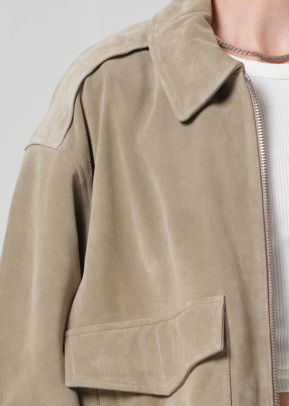 Close-up of a beige jacket with a neutral background