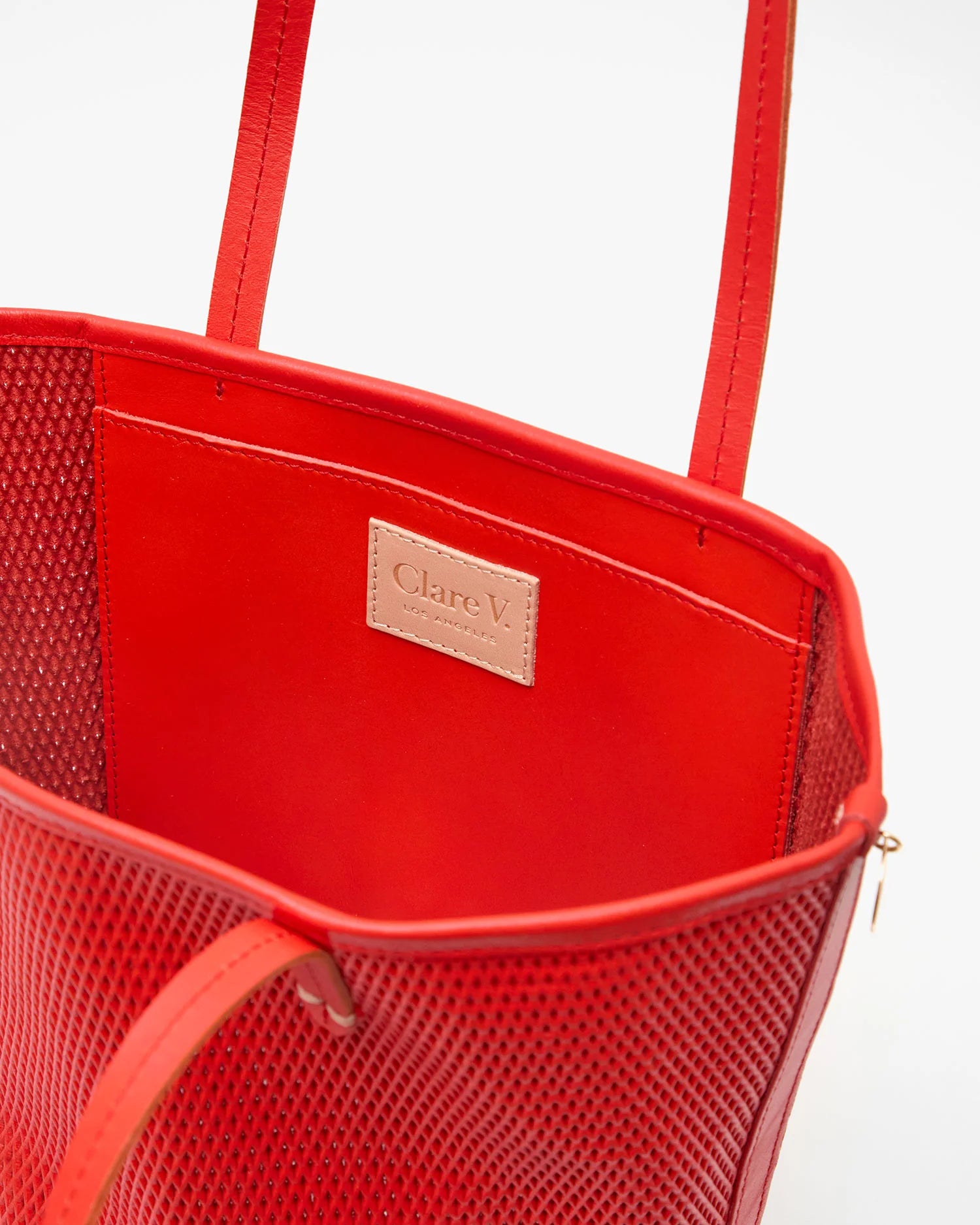 Red handbag with a visible brand logo on a white background