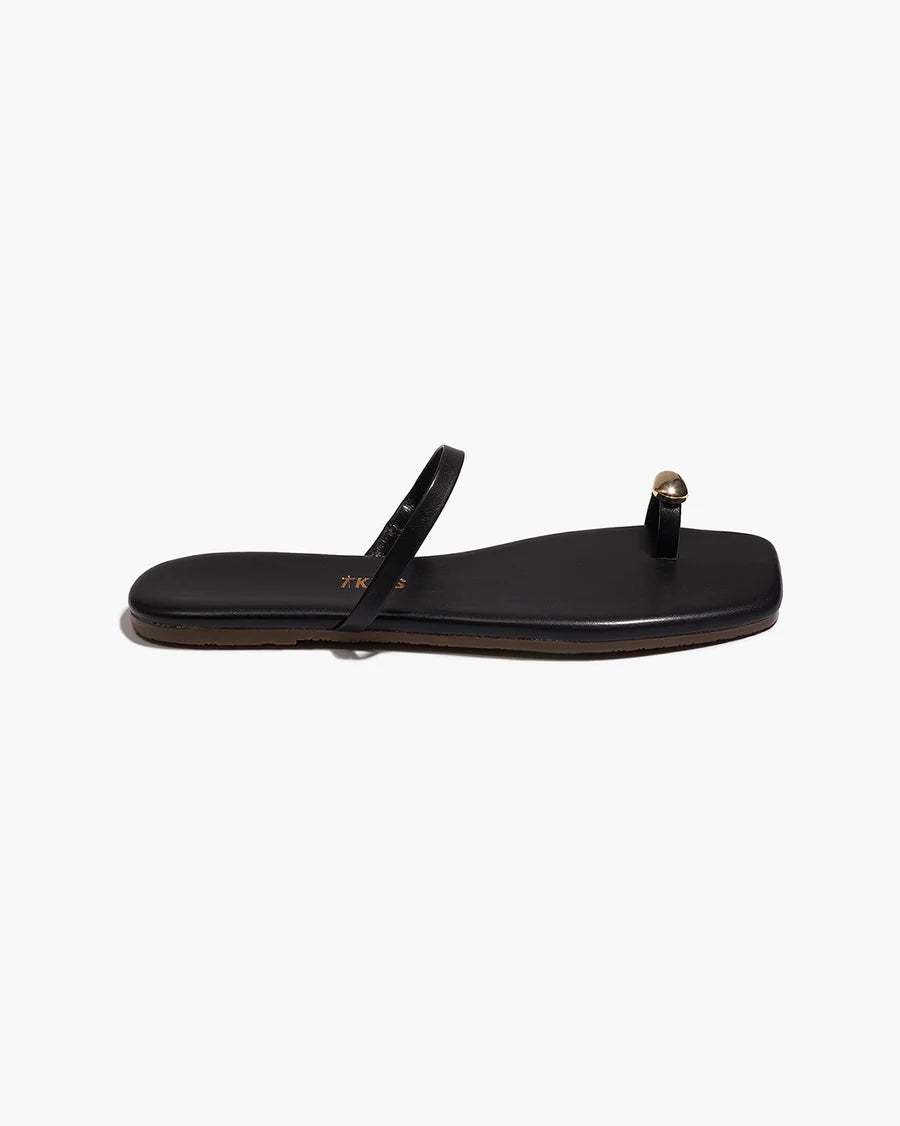 Black sandal with a strap on a white background