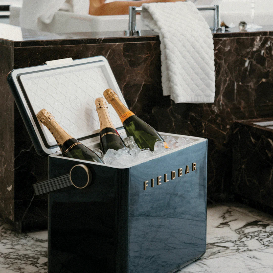 Fielder ice bucket with champagne bottles on a marble floor