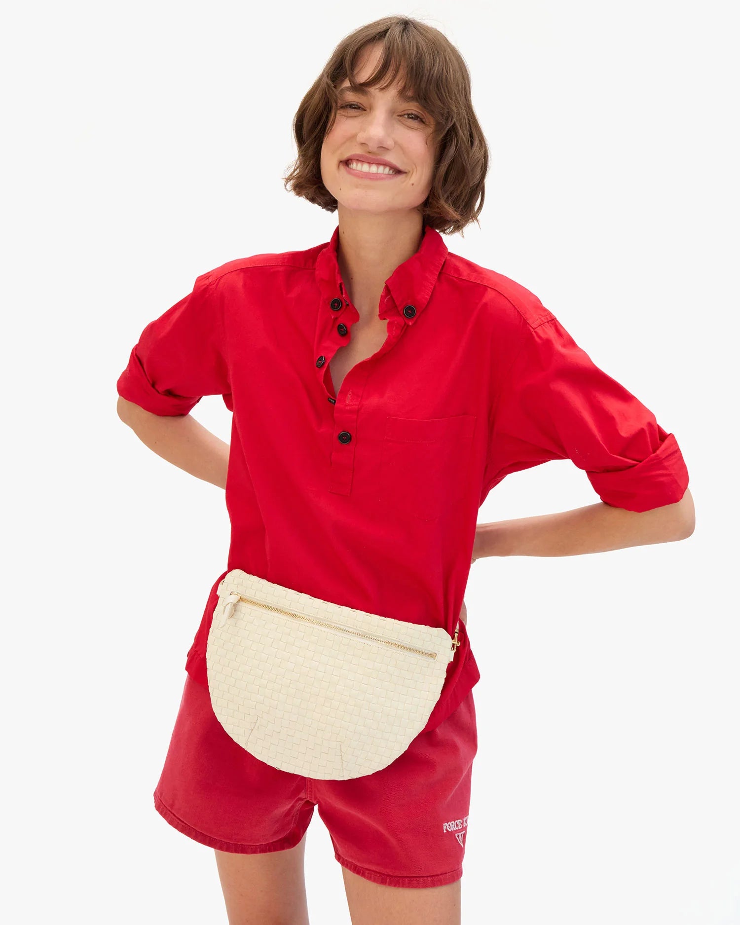 Person wearing a red outfit with a white waist bag on a white background