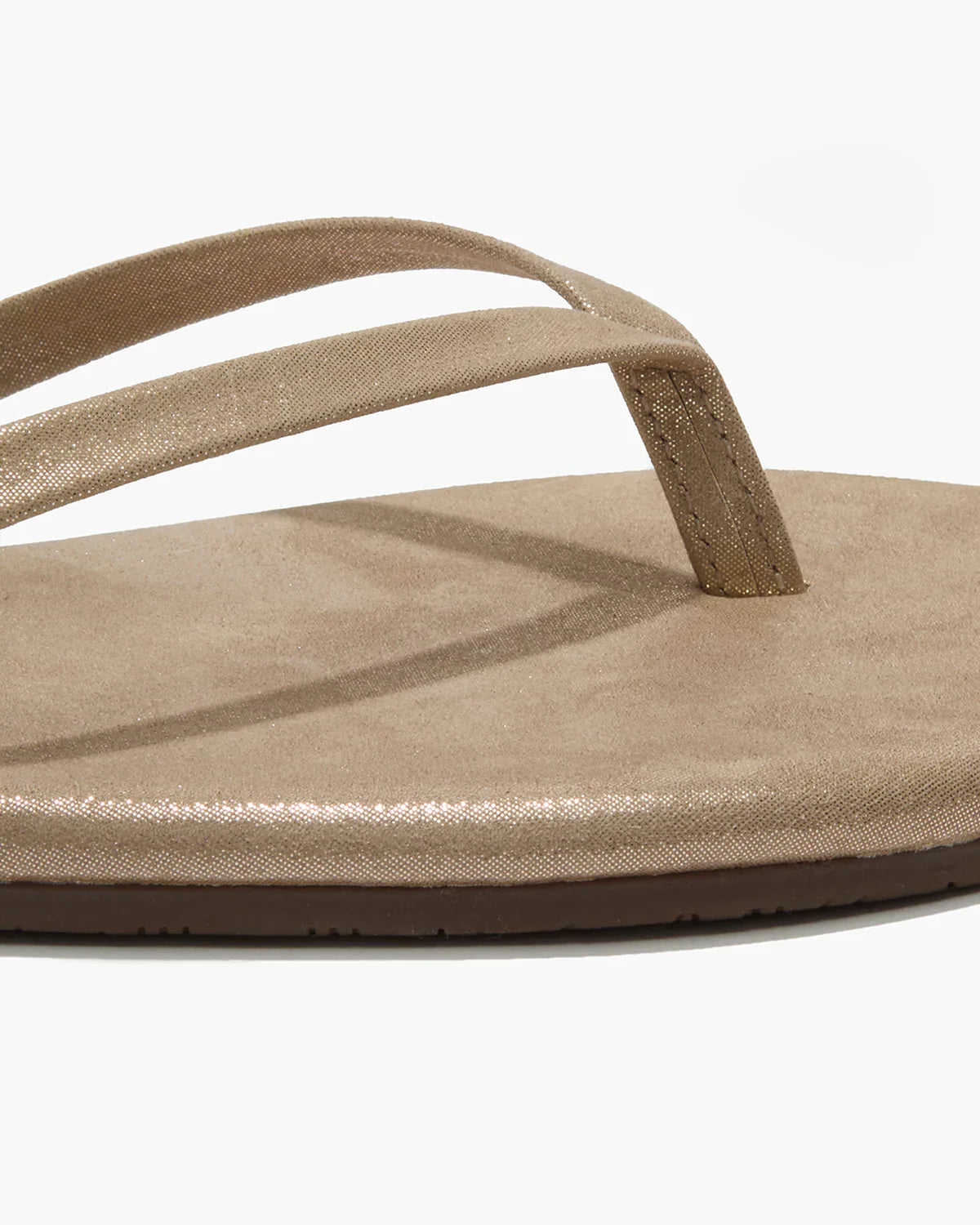 Beige sandal with a thong design on a white background