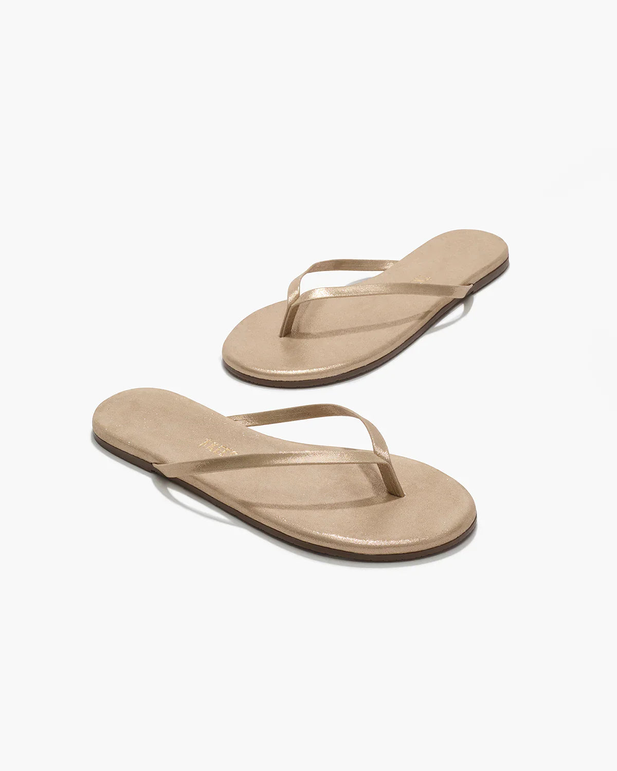 Pair of beige sandals on a white background