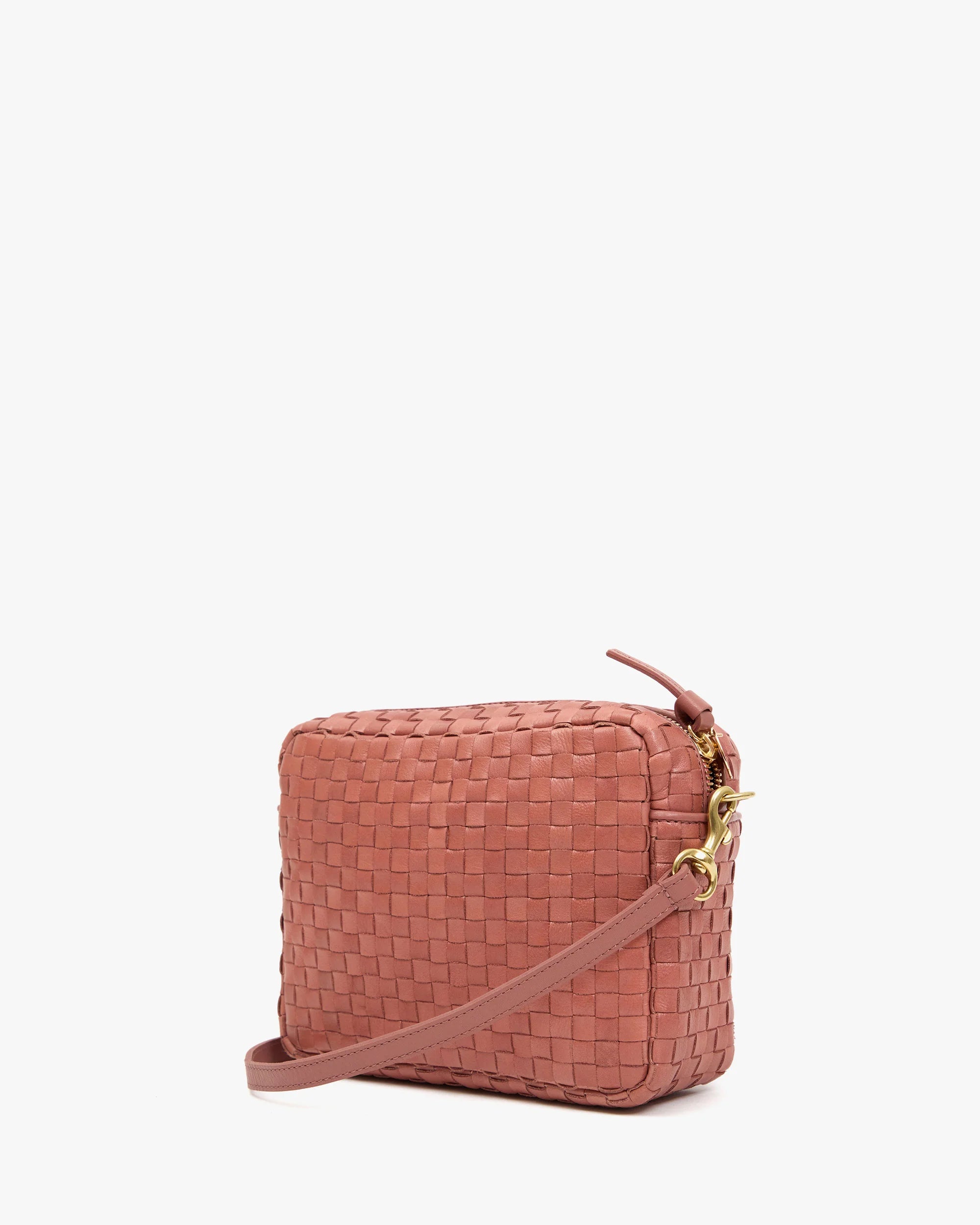 Pink woven handbag on a white background