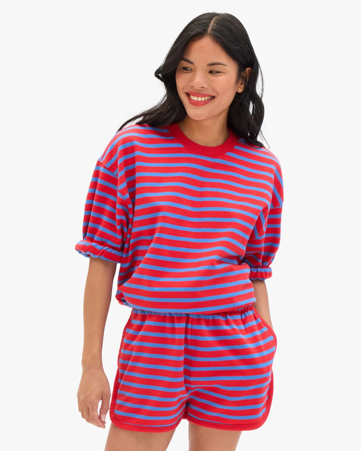 Woman wearing a red and blue striped outfit on a white background