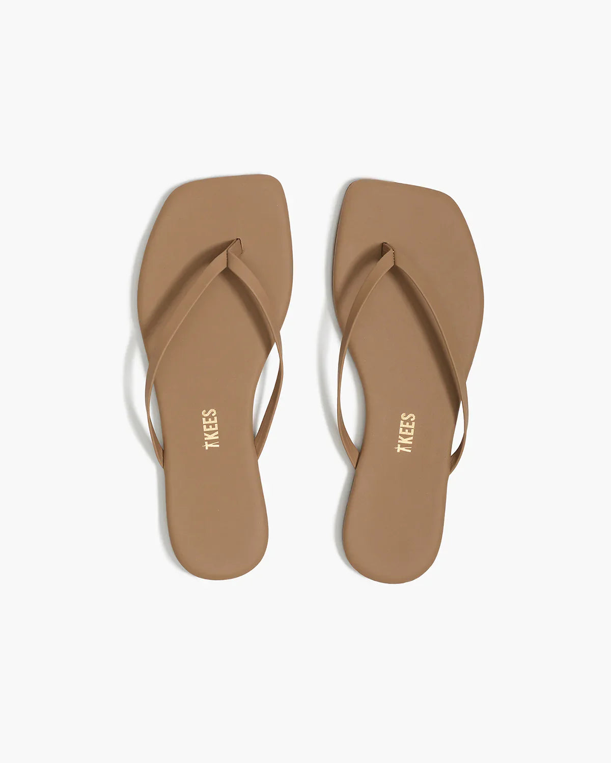 Pair of tan sandals on a white background