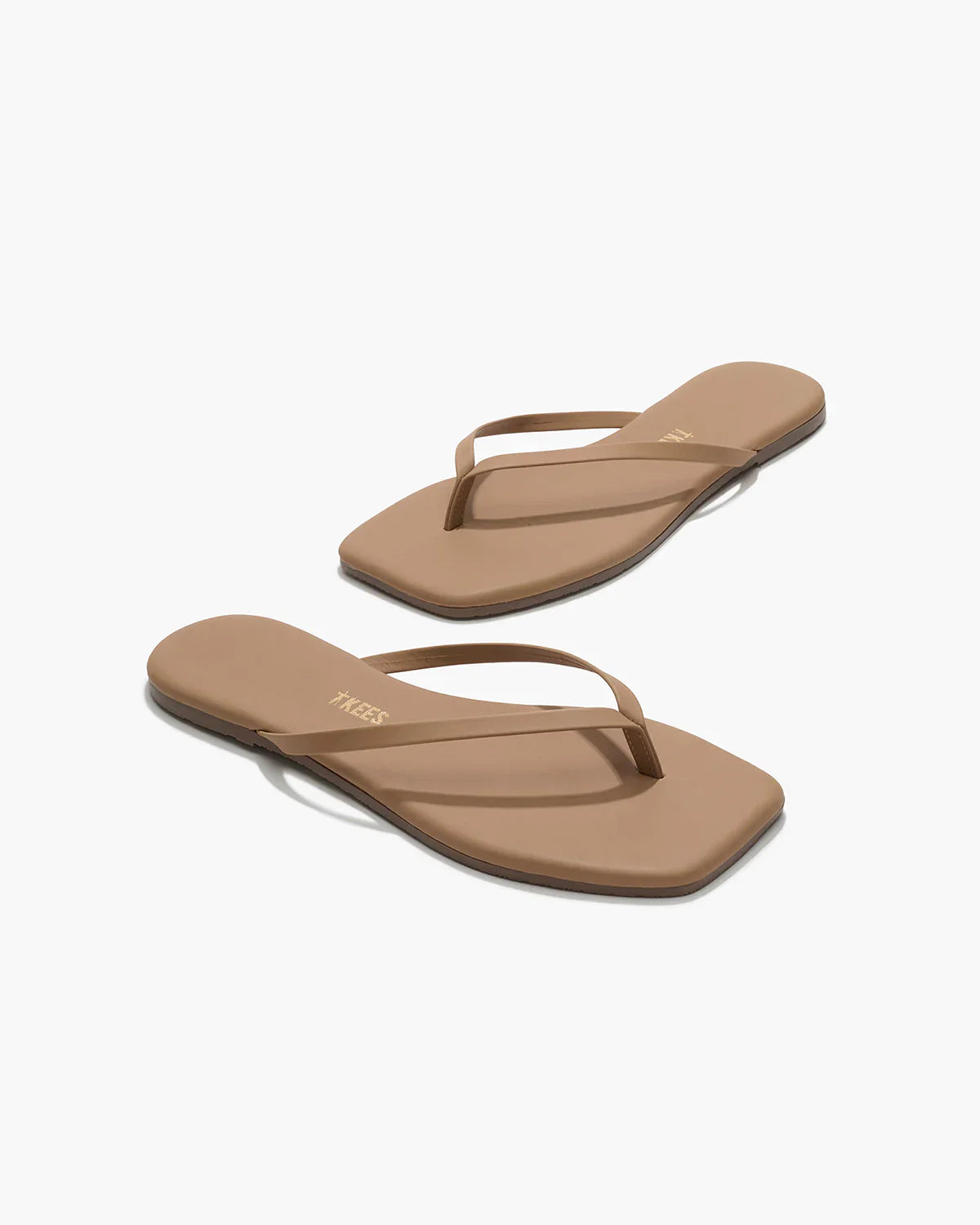 Pair of brown flip-flops on a white background