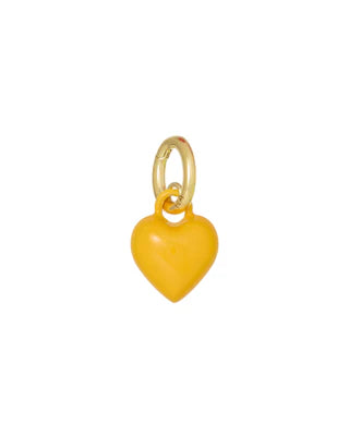 Heart-shaped charm with gold ring on a white background