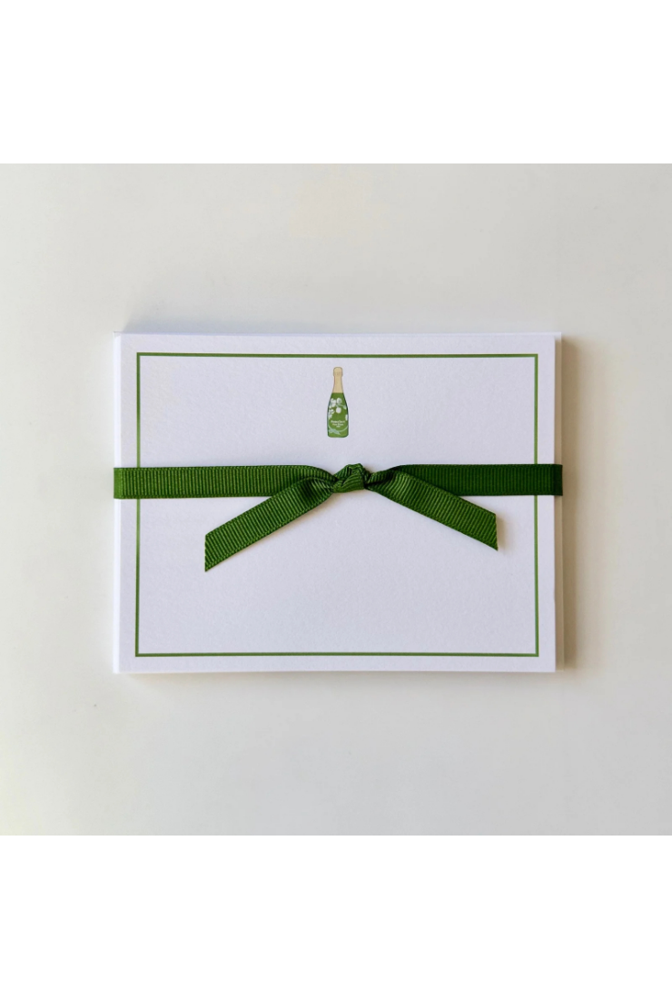Note card with green ribbon and bottle illustration on a white background