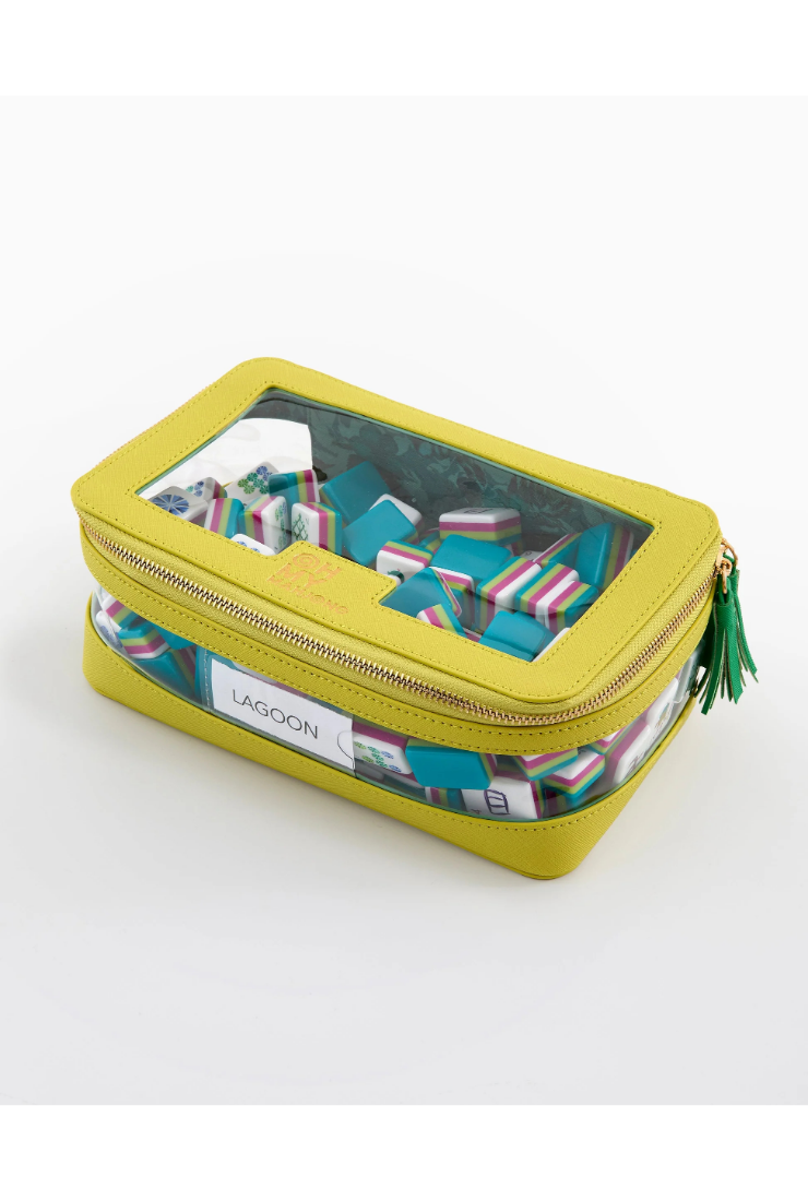 A lime green zippered carrying case with a clear top window showing colorful dominoes inside. The case has a white label with the brand name 'LAGOON' and a green tassel zipper pull, set against a plain white background.