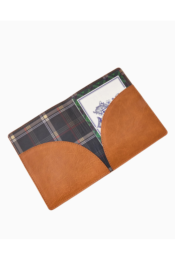 A brown leather passport cover or document holder with a plaid patterned interior and a card slot holding a travel ID card, shown on a plain white background.