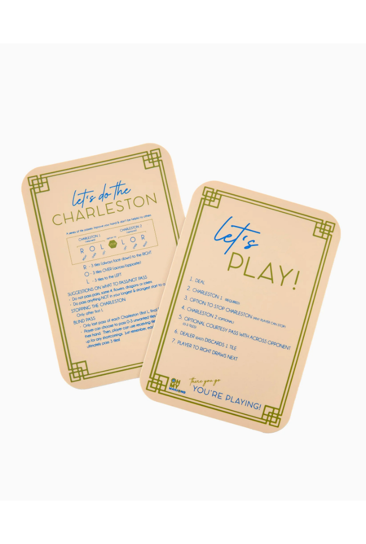 Two beige game cards with green decorative borders and blue text, shown on a plain white background. One card reads 'let's do the CHARLESTON' and the other reads 'let's PLAY!' with a list of play instructions.