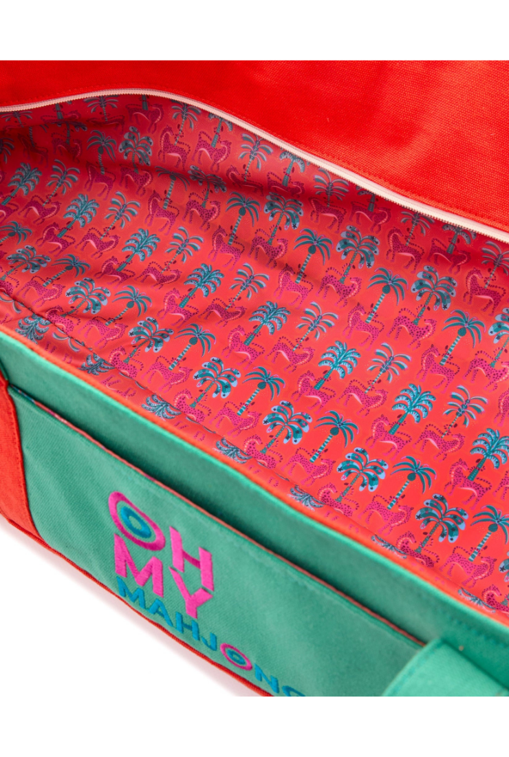 Close-up of a colorful bag with palm tree pattern and 'OH MY' text.