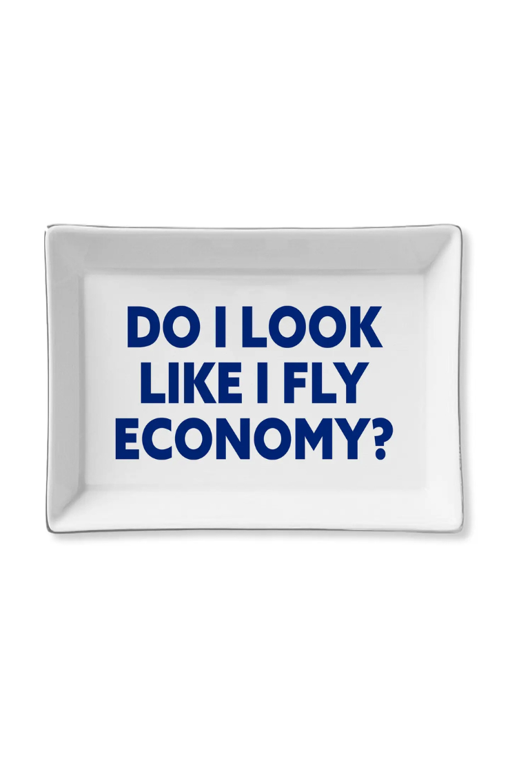 White tray with blue text 'DO I LOOK LIKE I FLY ECONOMY?' on a white background