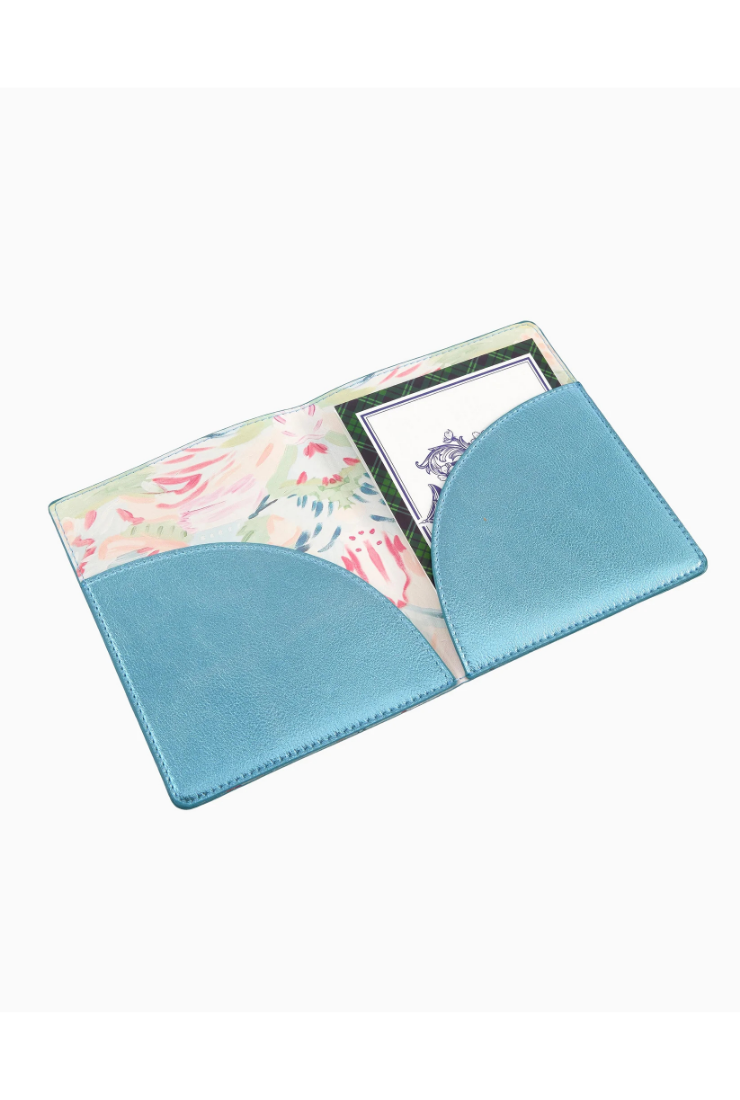 A light blue faux-leather passport cover with a floral patterned interior lining and a clear ID window, shown on a plain white background.