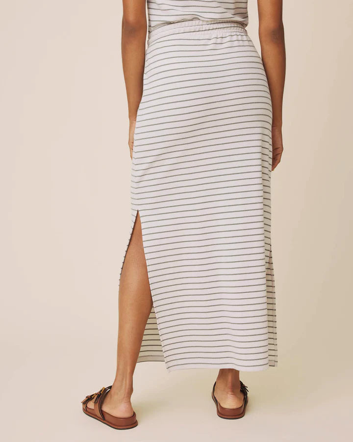 Person wearing a striped skirt with a plain background