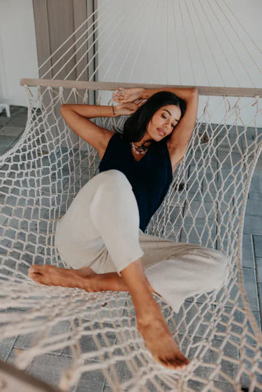 Woman relaxing in a hammock on a tiled floor