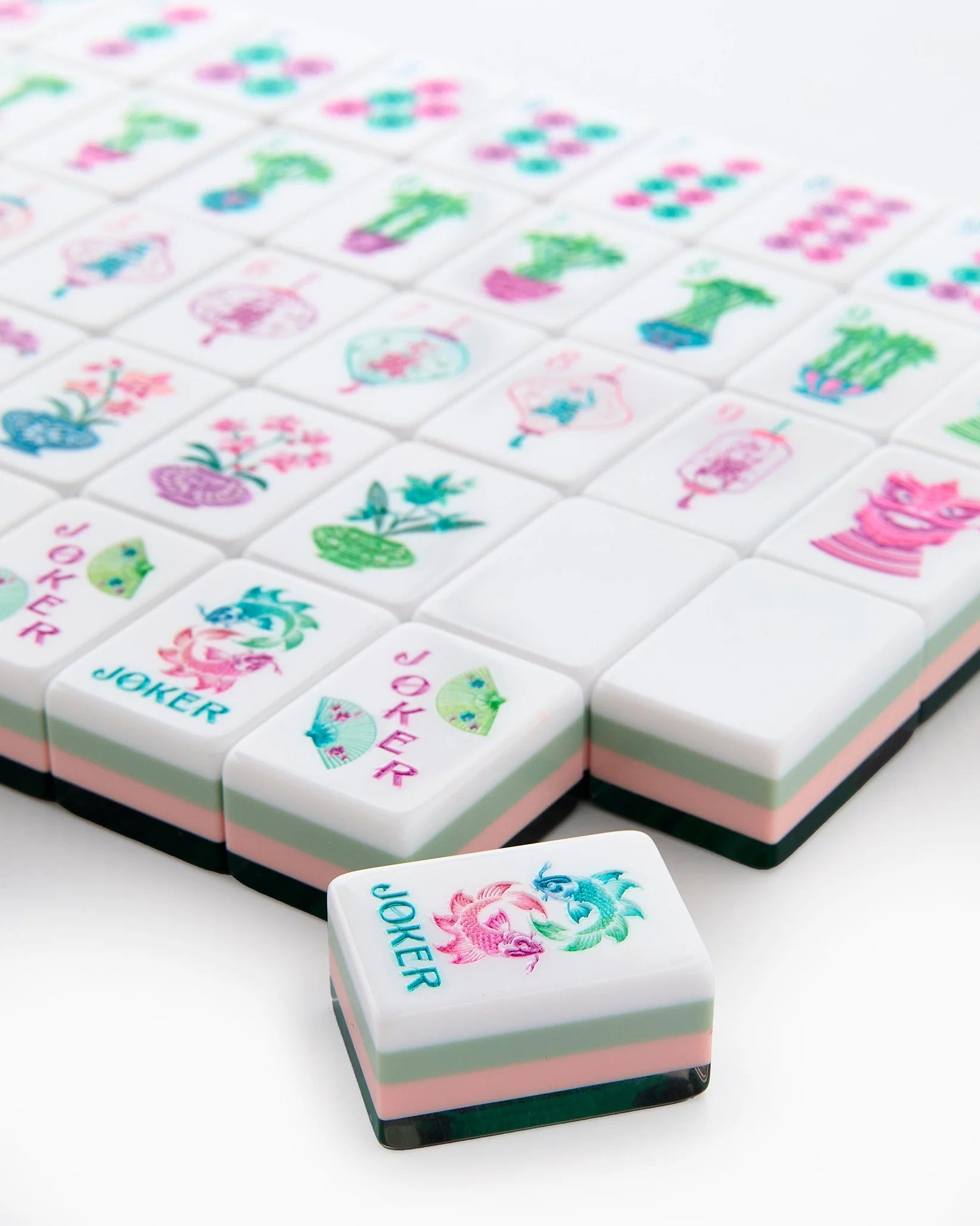 Decorative game pieces with colorful designs and 'Joker' text on a white background