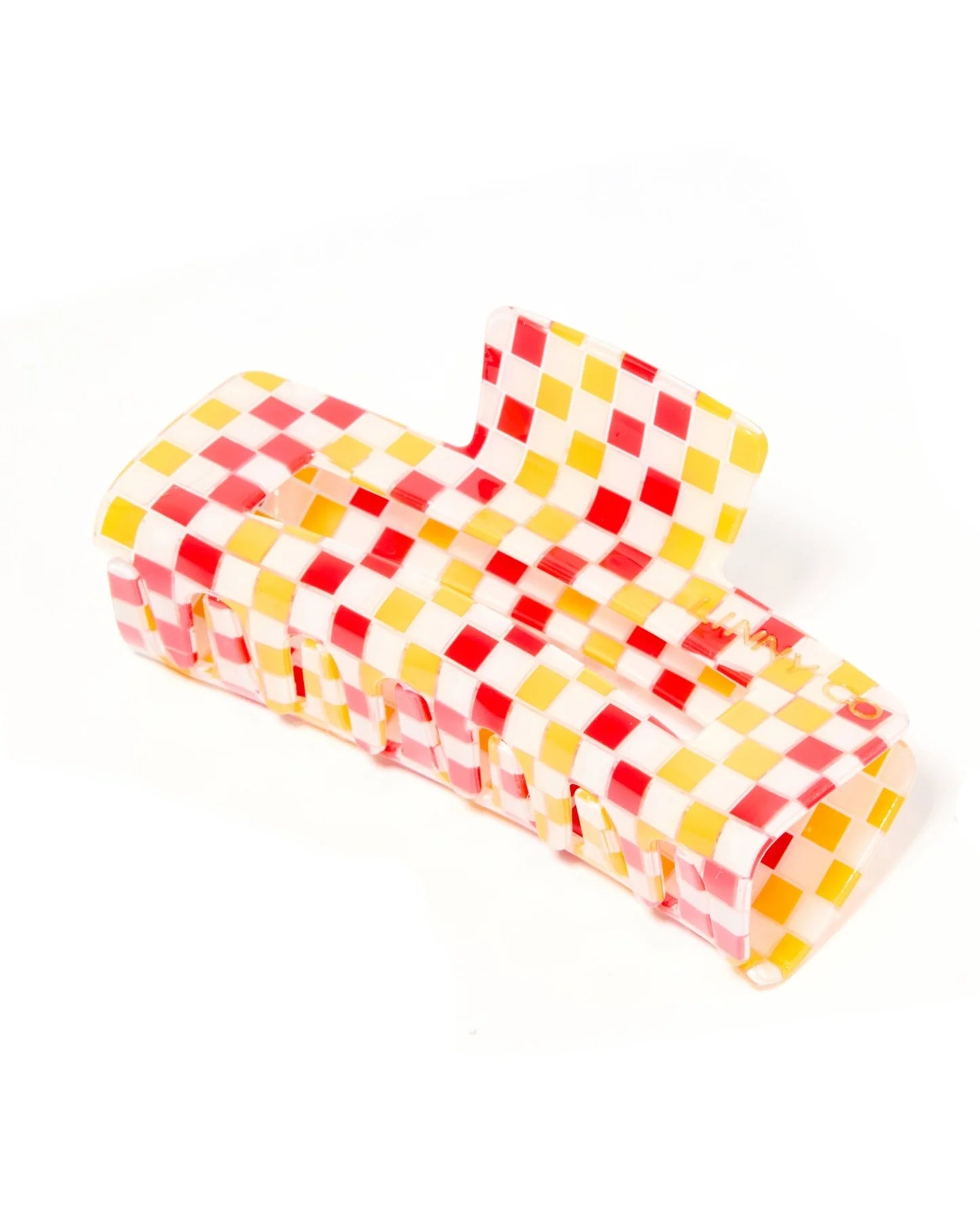 A translucent plastic claw hair clip featuring a red, yellow, and white checkerboard pattern, shown on a plain white background.