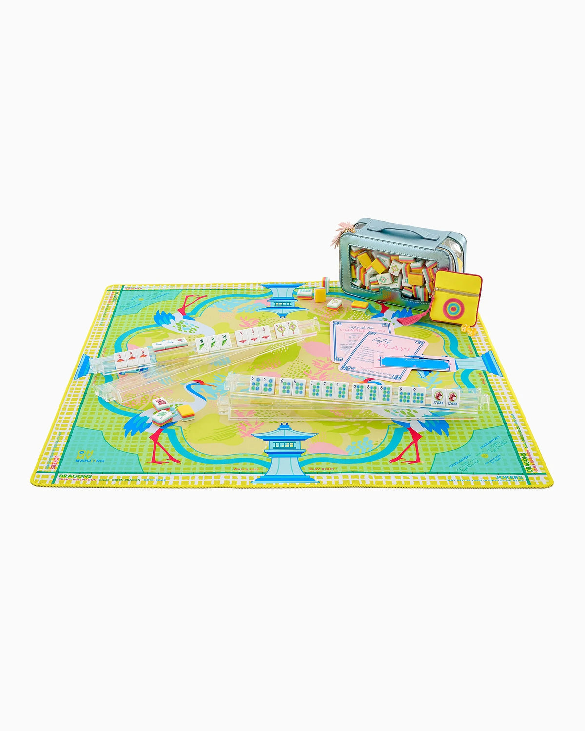 A colorful children's board game set with a playmat, game pieces, cards, and a small storage case, photographed on a plain white background.