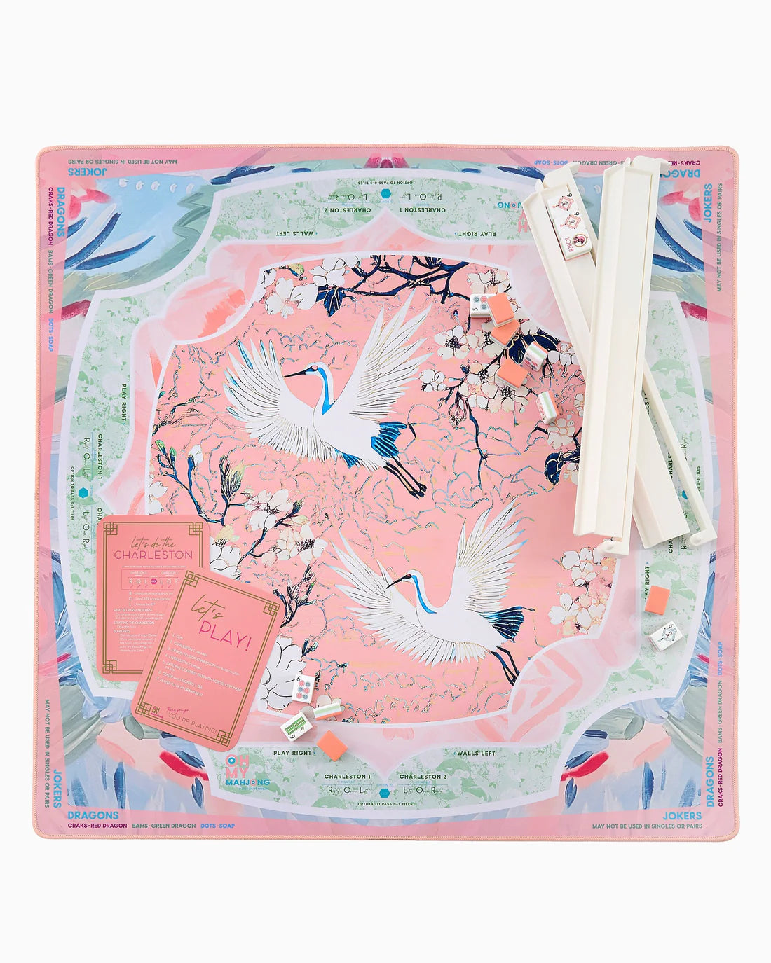 Decorative desk pad with crane design and stationery items on a white background