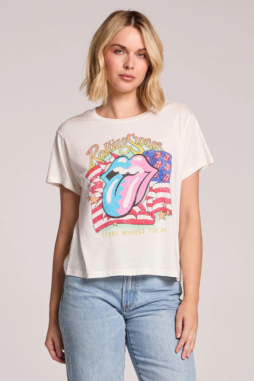 Person wearing a Rolling Stones t-shirt with a colorful graphic design on a plain background