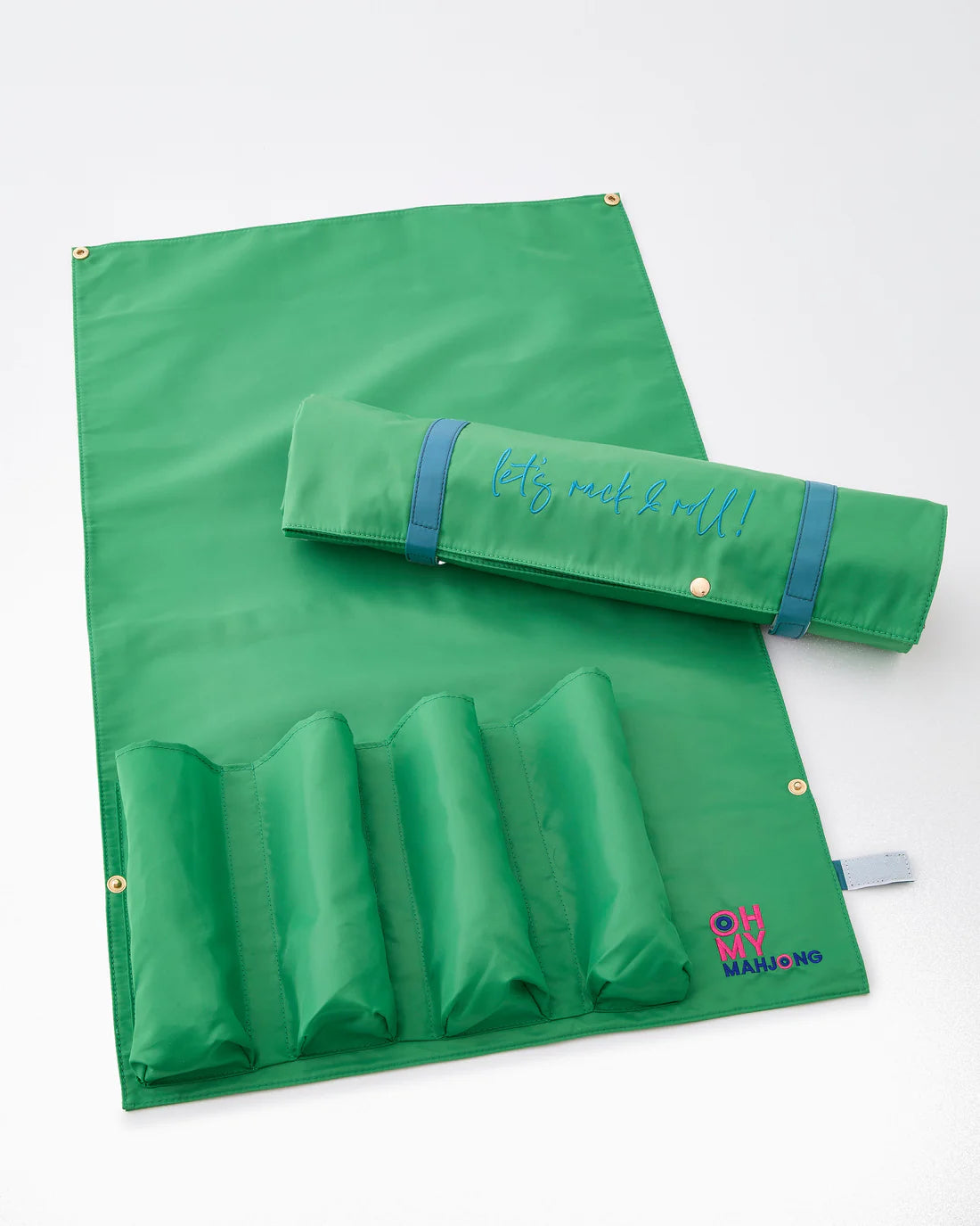 Green play mat with rolled-up mat and pouch on a white background