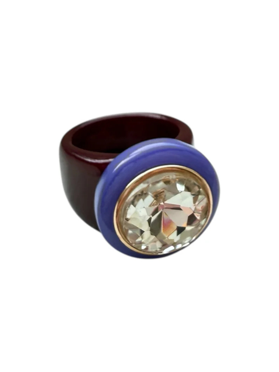 Ring with a purple band and a large crystal on a white background