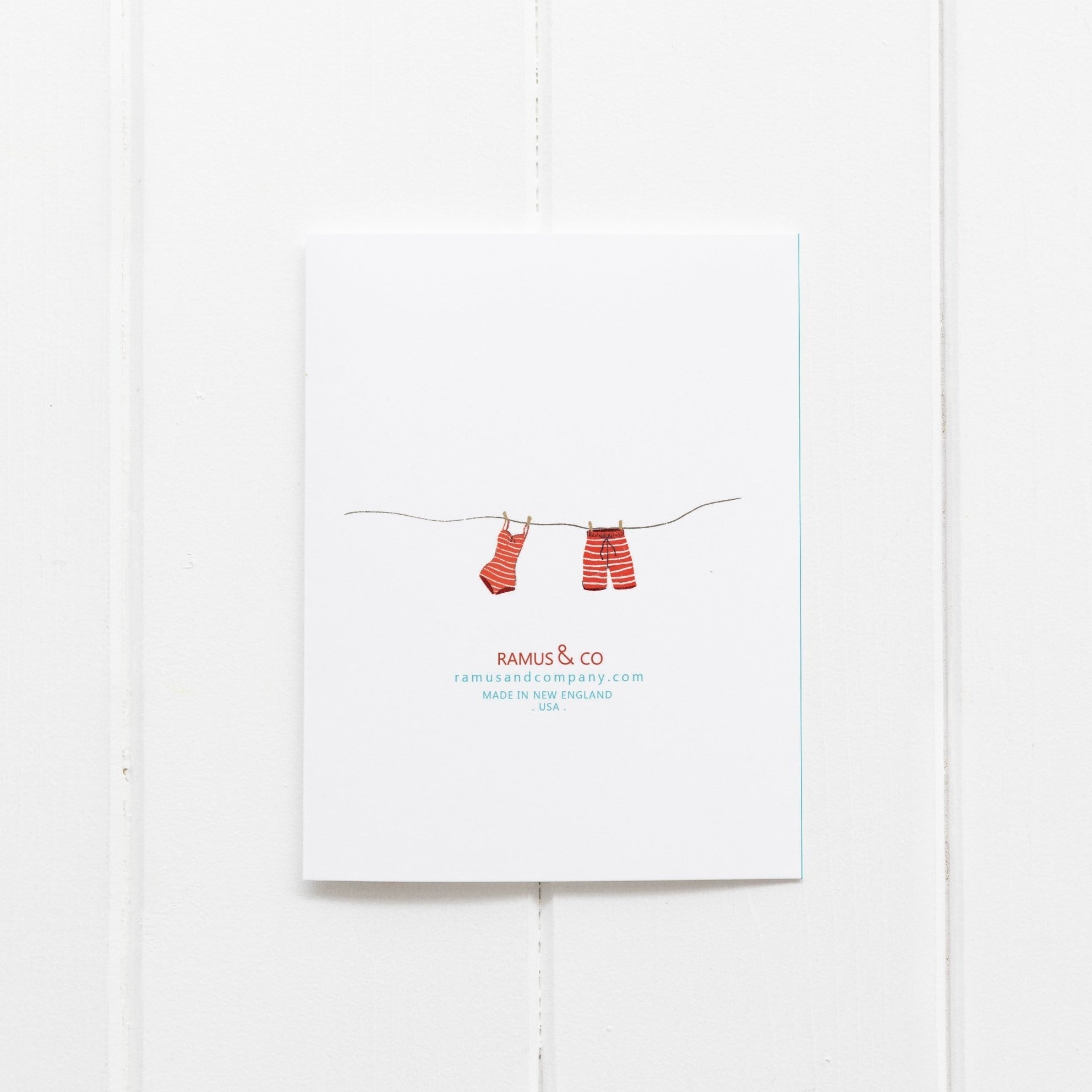 Notebook with red socks on a string design and 'Ramus & Co' branding on a white background