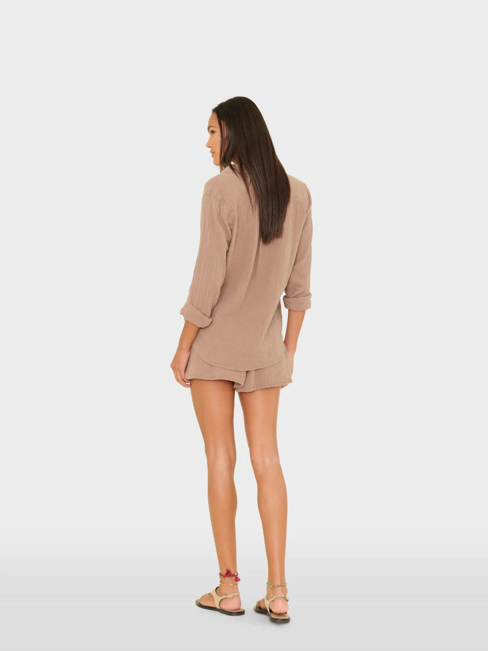 Woman wearing a beige dress on a white background