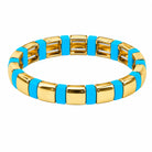 Gold bracelet with blue accents on a white background