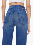 Blue jeans worn by a person on a white background