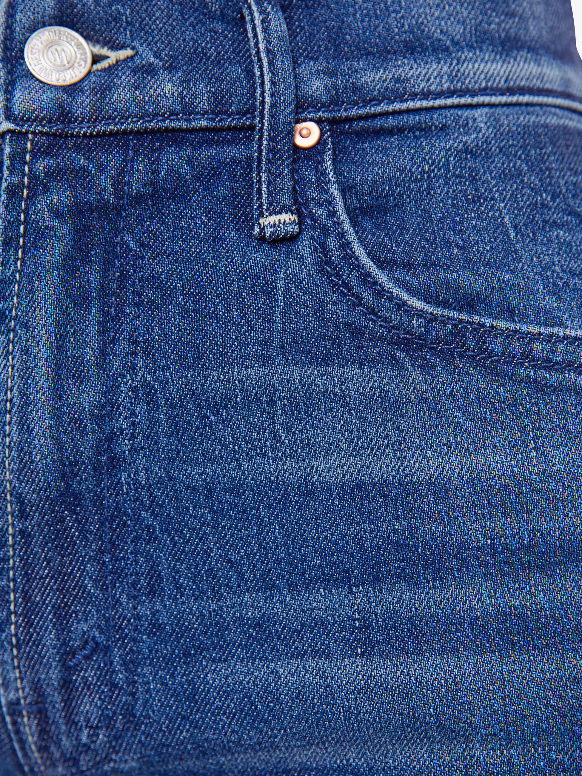 Close-up of blue denim fabric with stitching details