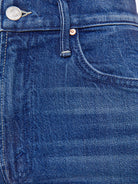 Close-up of blue denim fabric with stitching details