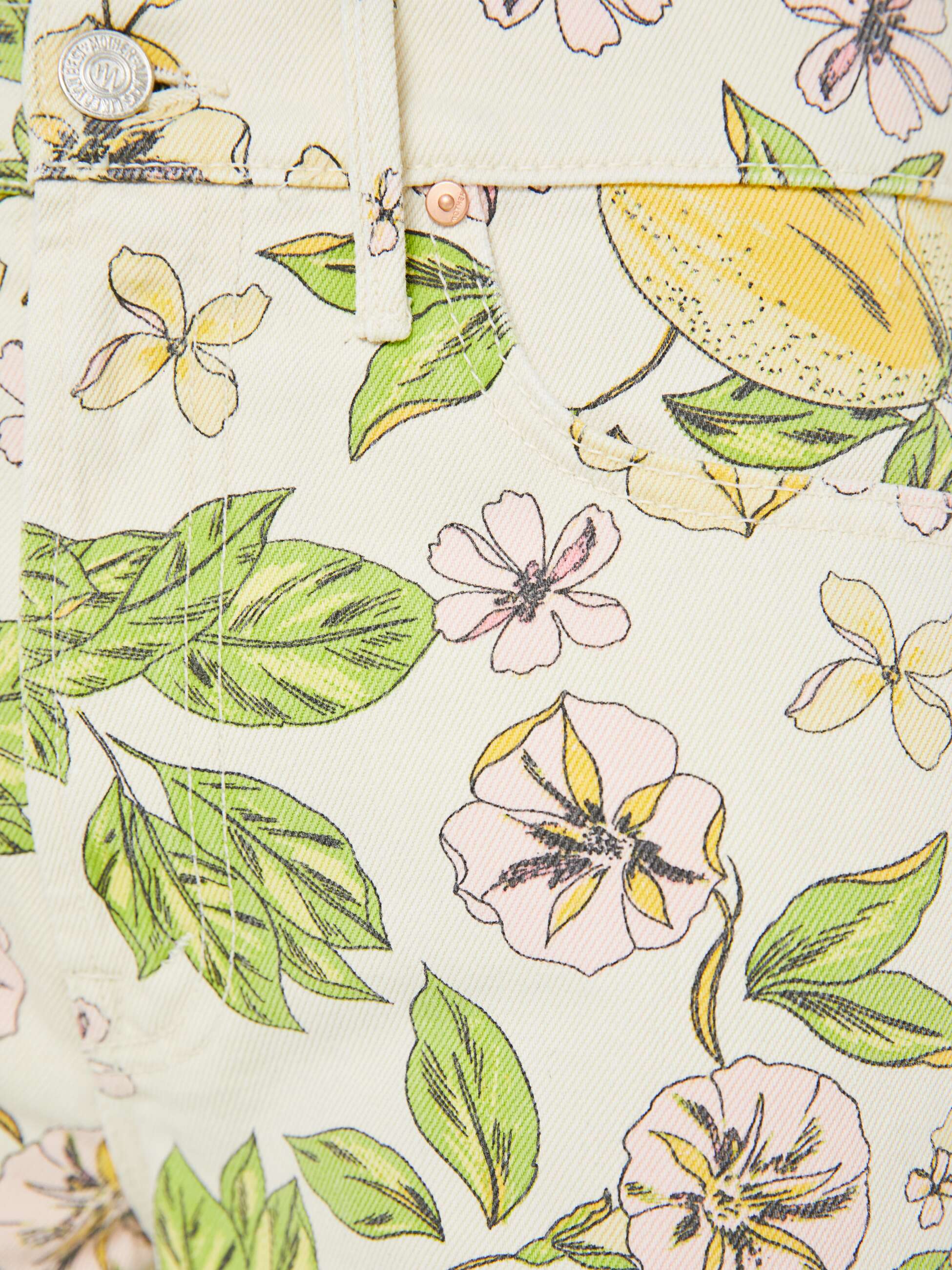 Close-up of a fabric with floral and leaf pattern on a light background