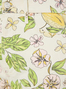 Close-up of a fabric with floral and leaf pattern on a light background