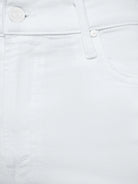 Close-up of white denim fabric with button details