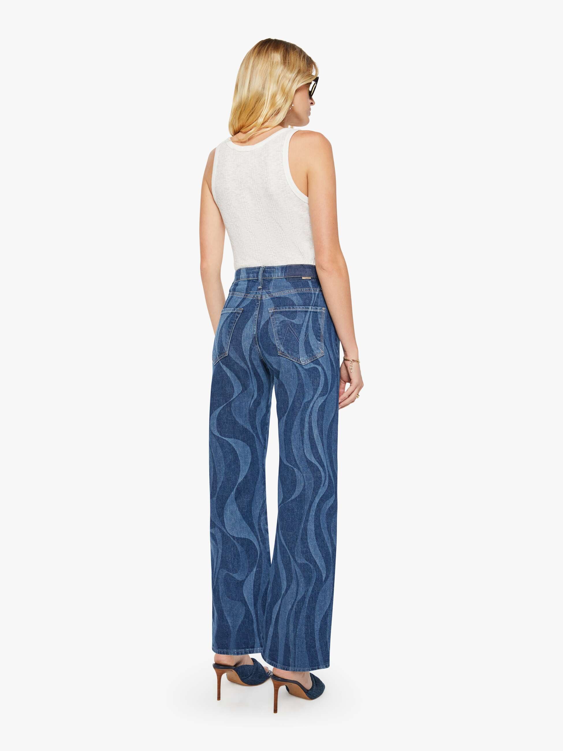 Woman wearing blue patterned pants on a white background