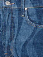 Close-up of blue denim fabric with stitching details
