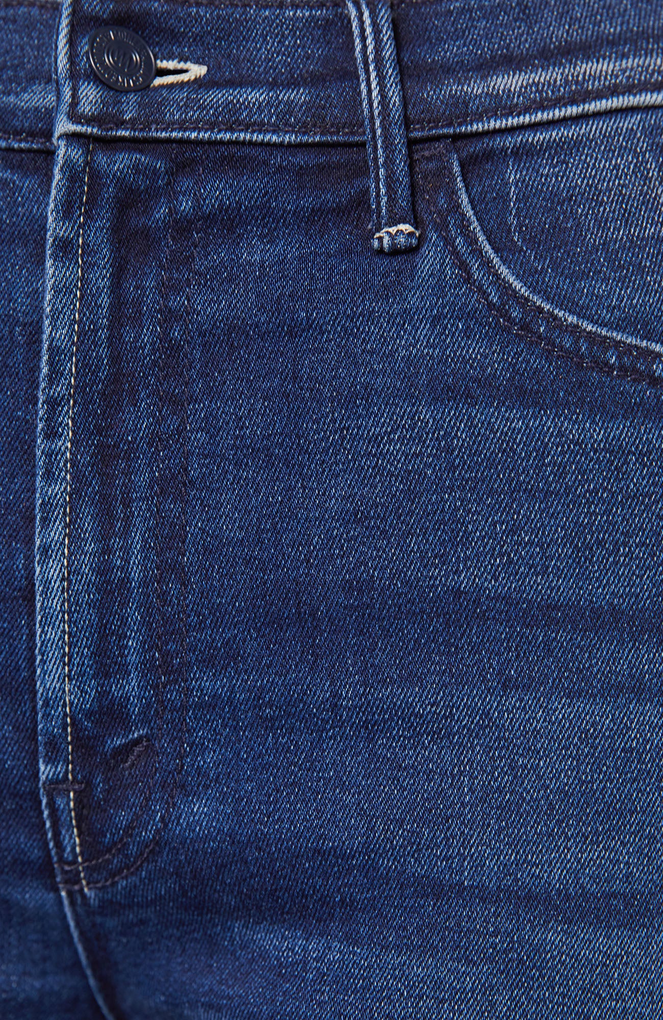 Close-up of blue denim fabric with stitching details