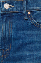 Close-up of blue denim fabric with stitching details
