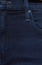Close-up of dark blue denim fabric with stitching details