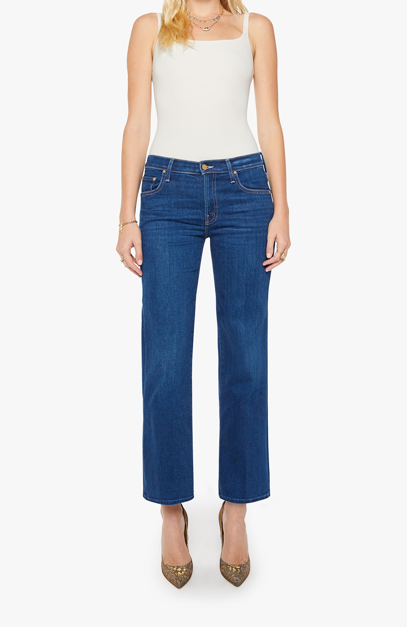 Woman wearing blue jeans and a white top on a white background